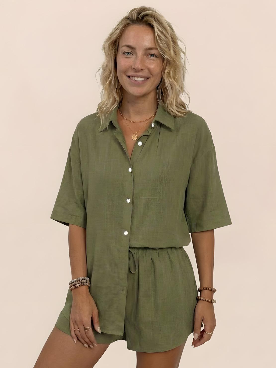 Woman wearing Coastal Linen Cotton two-piece set with button-down top and shorts in a natural setting