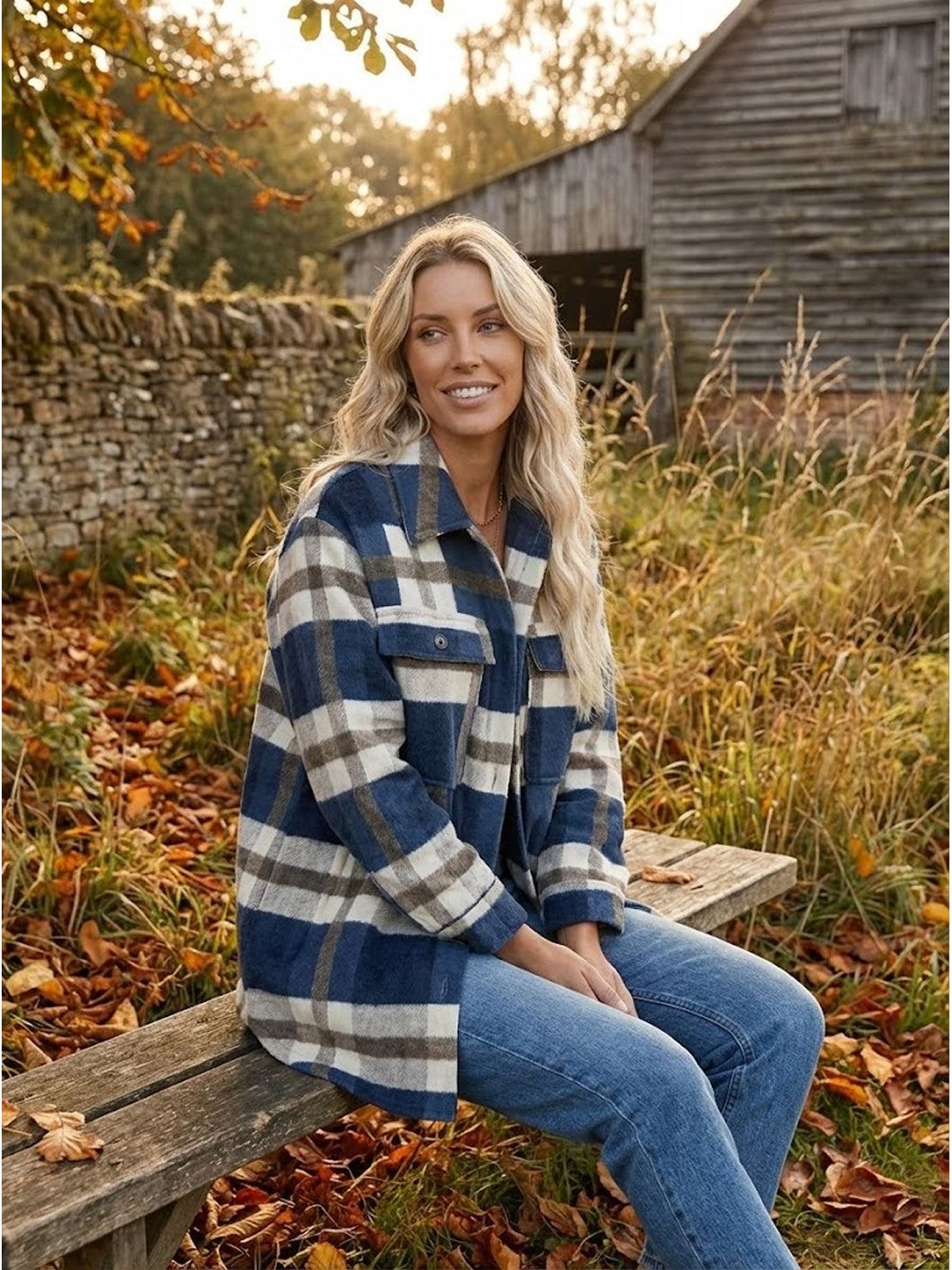 Woman wearing comfy flannel classic button-down shirt sitting outdoors in autumn setting