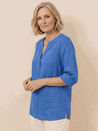 white pure linen age-defying shirt with button detail on wooden hanger