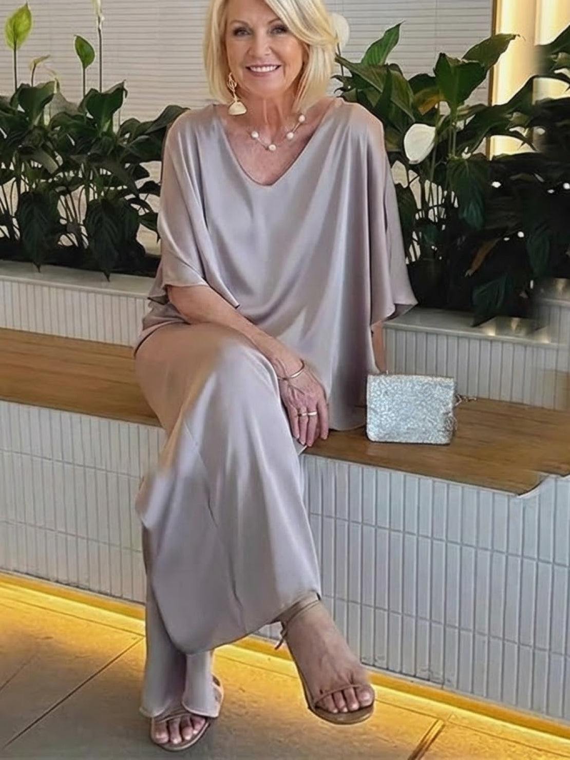 Woman wearing elegant layers two-piece set with layered V-neck top and matching pants