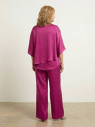 Woman wearing Elegant Layers Two-Piece Set with layered V-neck top and matching pants in soft fabric.