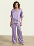 Woman wearing elegant layers two-piece set with flared sleeves and V-neck top