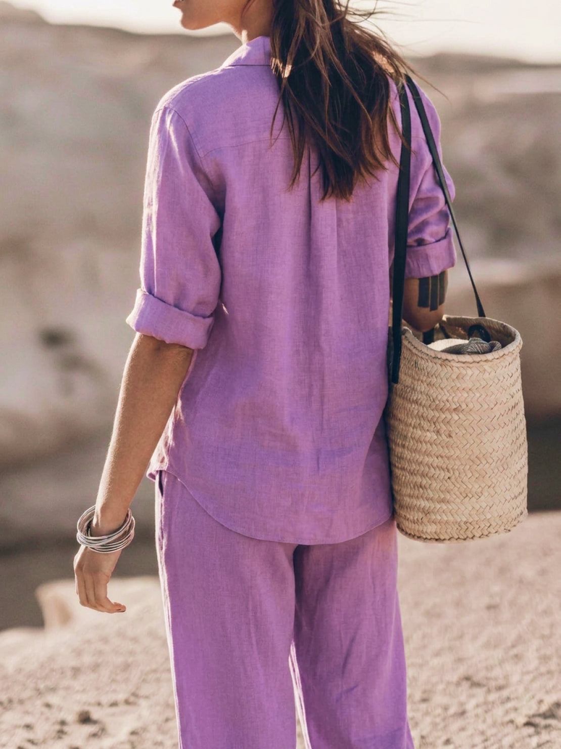 Woman wearing an oversized 100% cotton shirt and wide-leg pants co-ord set in neutral tones