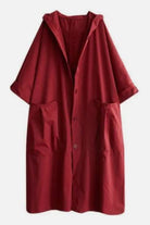 Oversized red water resistant windbreaker jacket with hood and front pockets