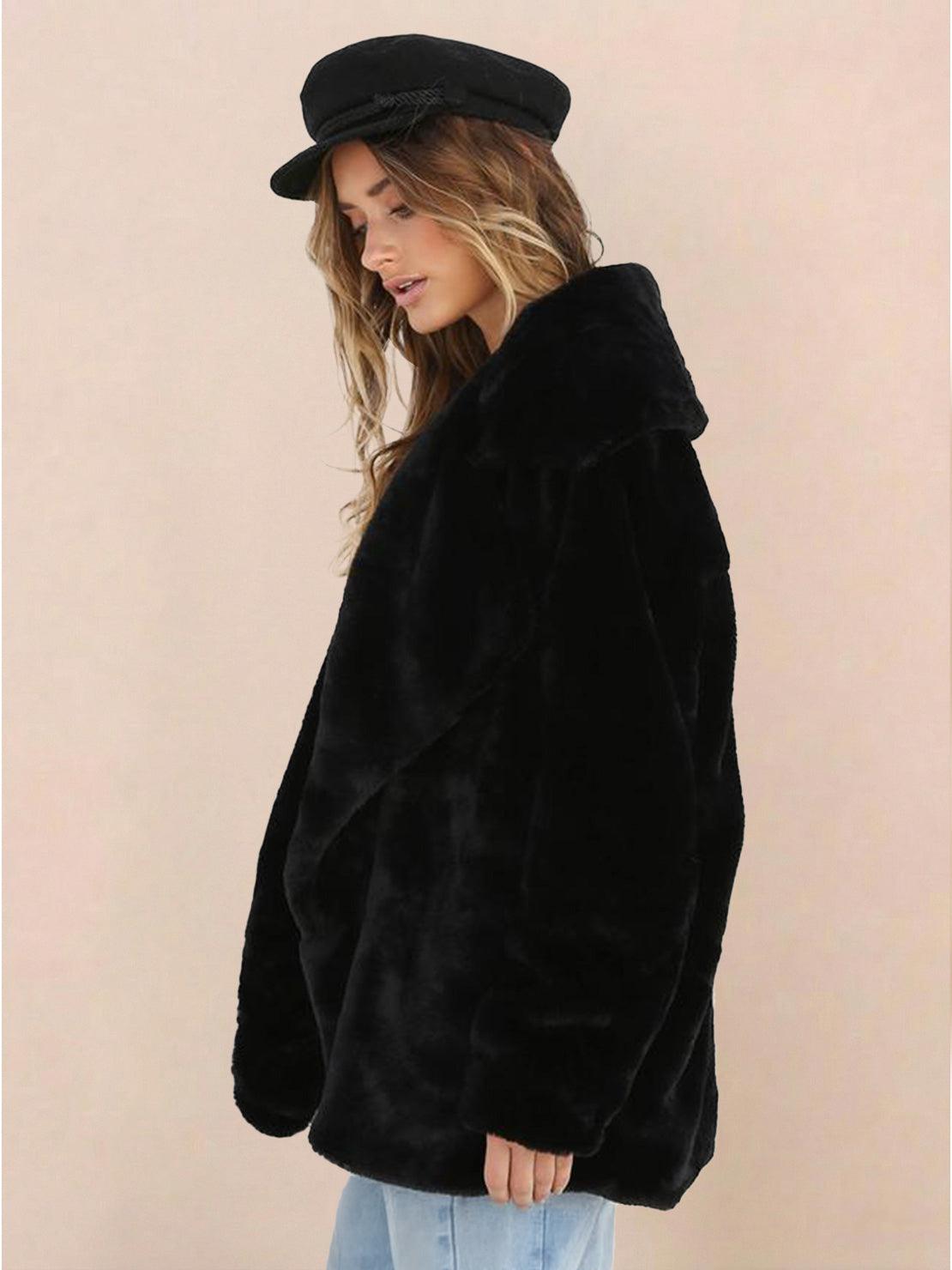 Woman wearing black open front oversized faux fur jacket with draped collar and relaxed fit
