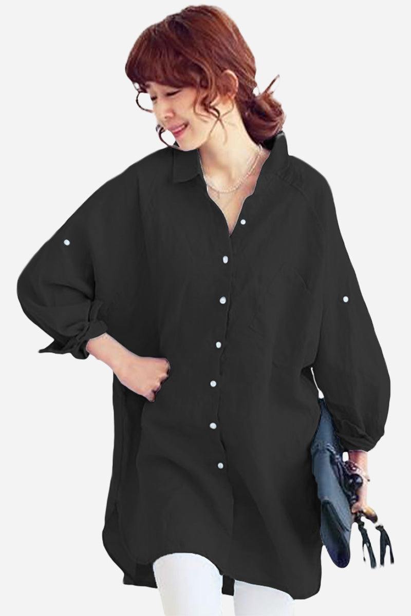 Woman wearing a black oversized linen shirt with relaxed fit and button details