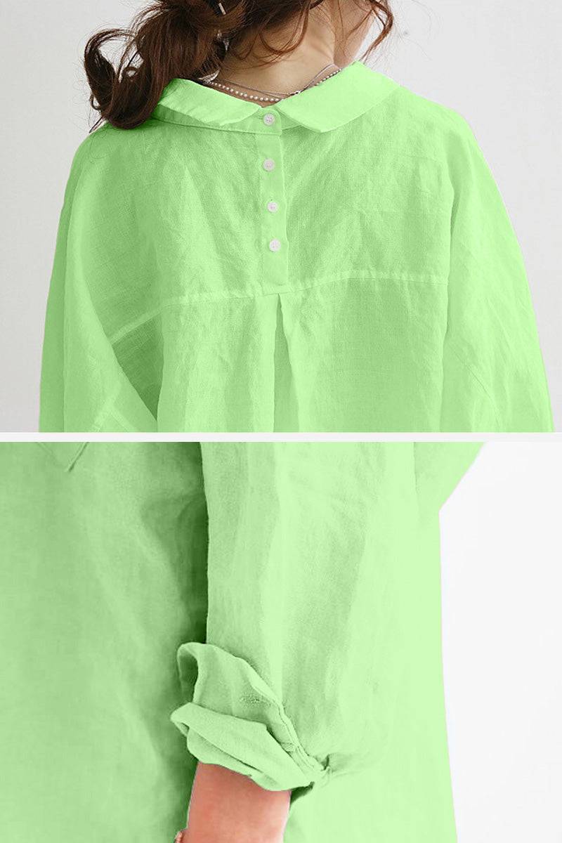 Green oversized linen shirt with buttoned collar and rolled-up sleeves