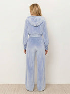 Modern cropped velour tracksuit set with high-waist pants in vibrant color and plush texture