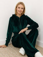 Modern velour tracksuit set with cropped hoodie and high-waist pants in plush polyester fabric