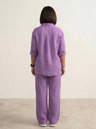 Woman wearing a relaxed shirt and trousers two-piece set in a monochrome casual style