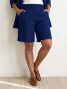 Woman wearing a stylish blazer and shorts two-piece set in vibrant blue color