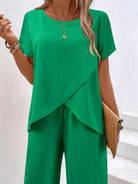 Woman wearing textured elegance two-piece set with asymmetrical top and wide-leg pants