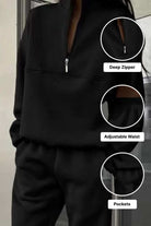 Black cotton blend tracksuit with deep zipper, adjustable waist, and pockets for comfortable, stylish wear