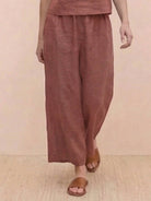 Woman wearing a loose fit co-ord set with a soft-tailored top and wide-leg bottoms in a relaxed meadow-inspired style