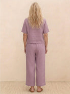 Woman wearing a loose fit co-ord set with a soft-tailored top and wide-leg bottoms in a relaxed, breathable fabric.