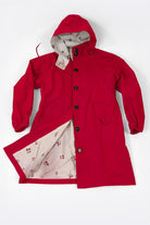 Red oversized Rain Couture Windbreaker with hood and floral patterned interior lining.