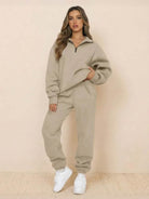Woman wearing beige ultra-soft and comfy co-ord tracksuit set with white sneakers against plain background