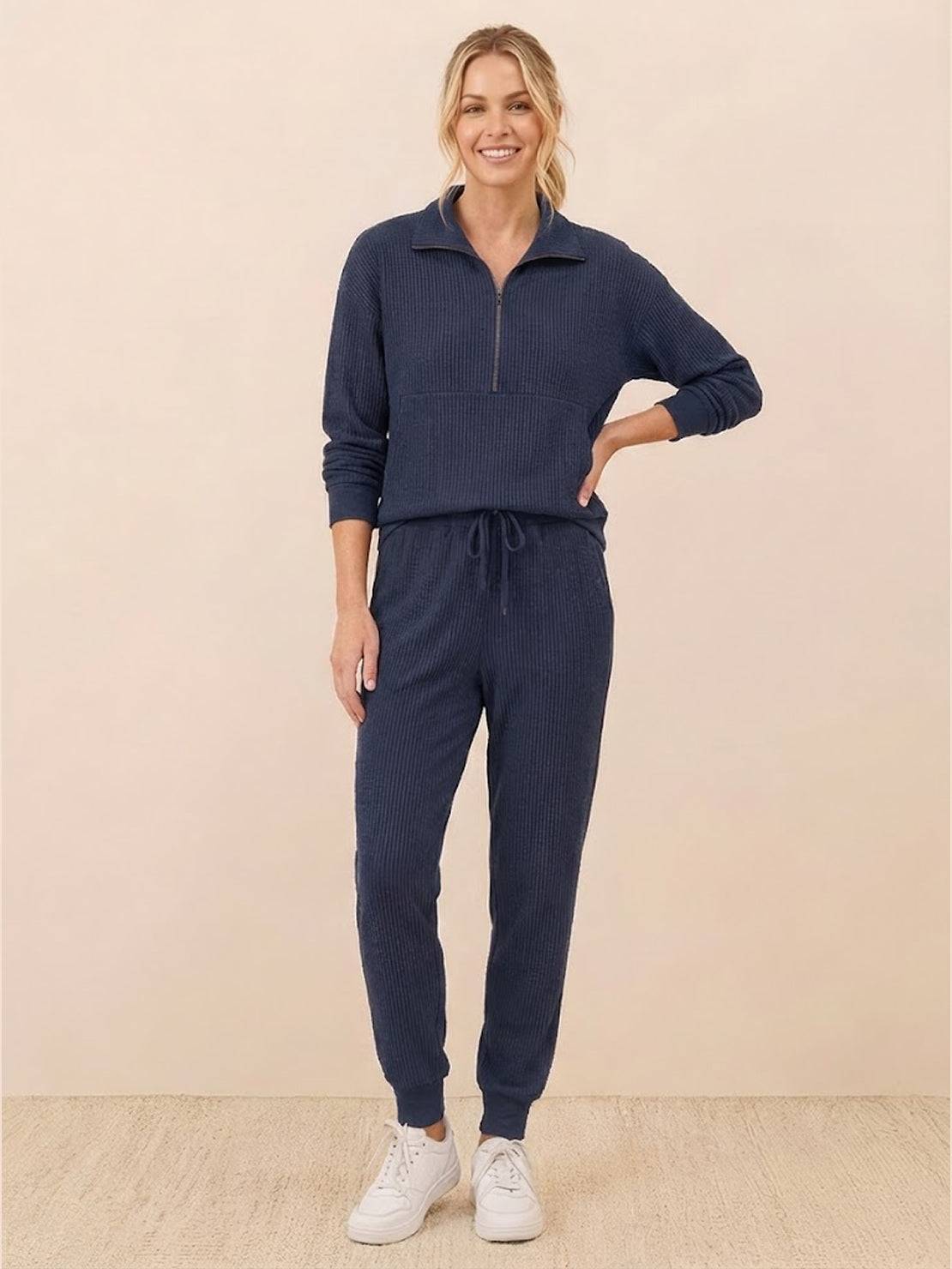 Unisex half-zip pullover and matching sweatpants set in soft fabric for casual comfort